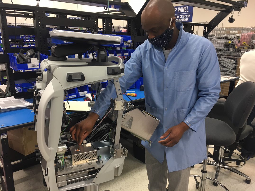 Image of Baxter Employee Manufacturing a blood purification System