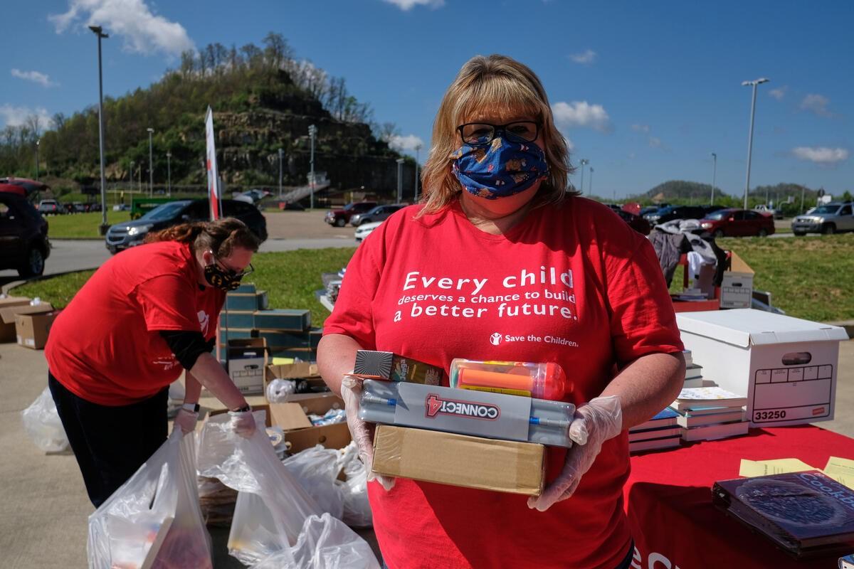 Image of volunteers packing care kits from Save The Children 